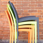 stack of livorno chairs. Multi coloured stack of chairs. Outdoor dining chairs stacked. Plastic outdoor chairs stacked